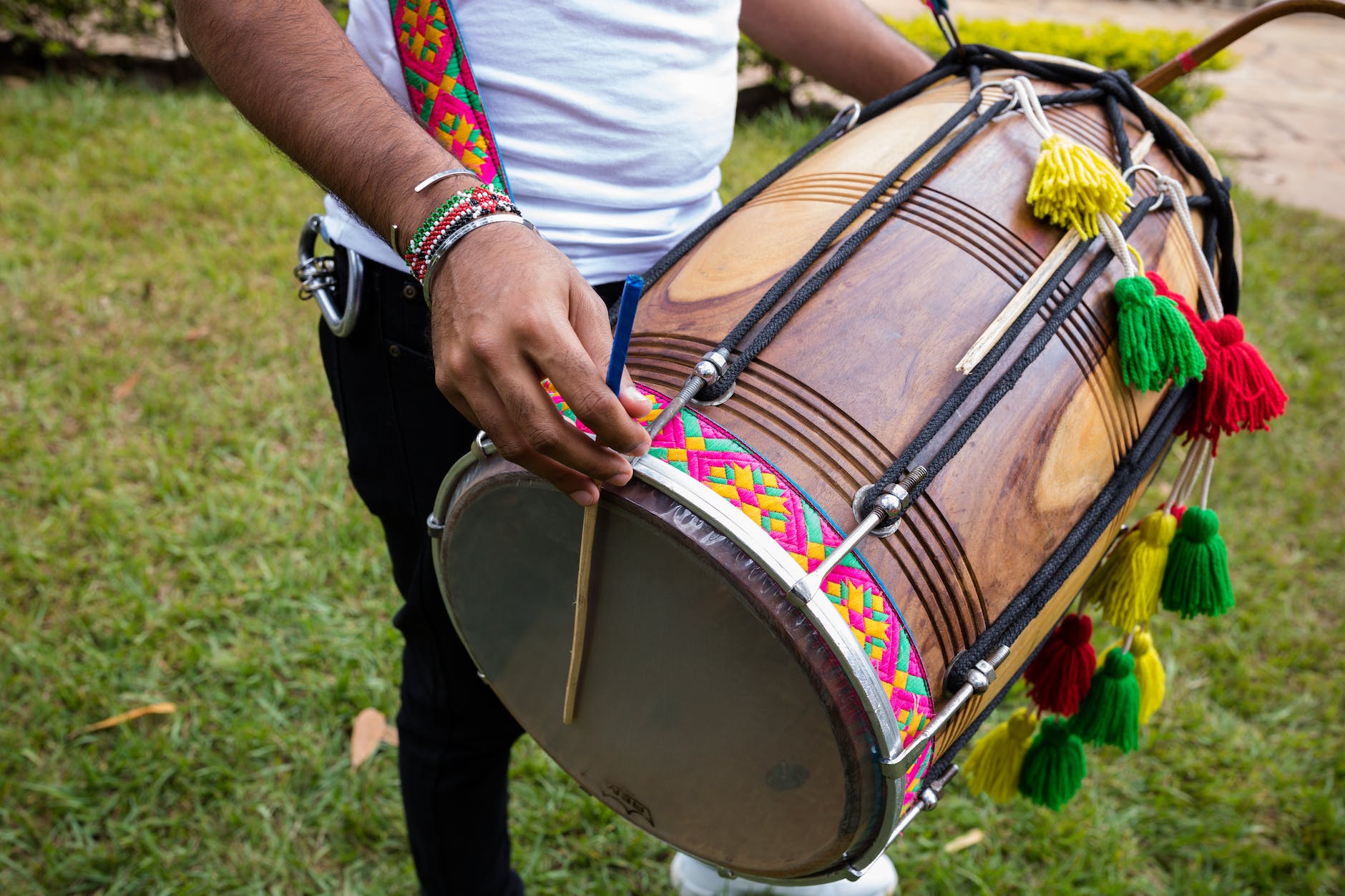 person in white shirt playing drum