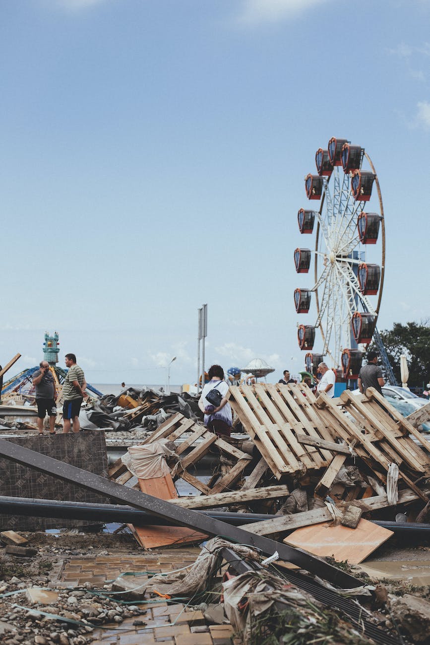 people walking on a site after a natural disaster