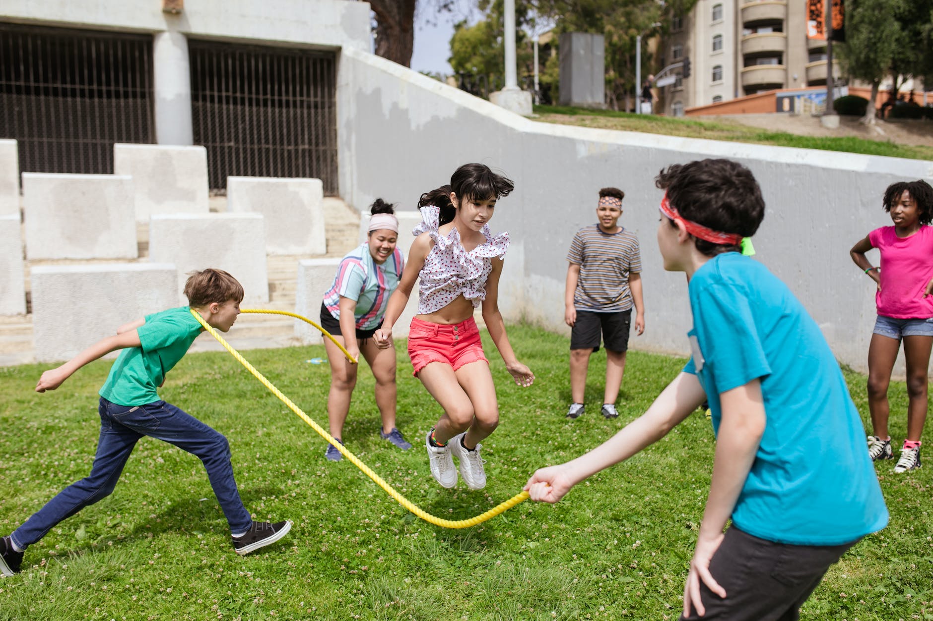 a group of kids playing jumping rope